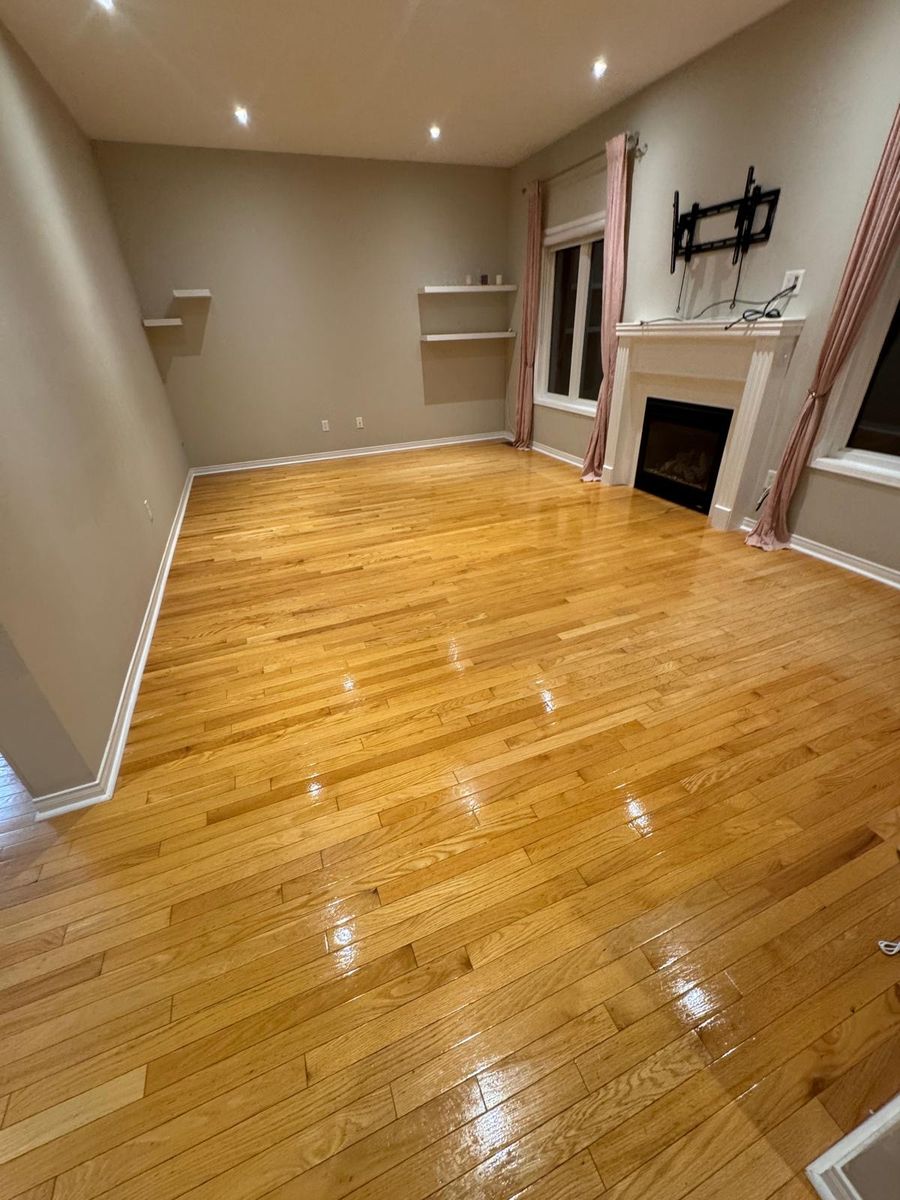 Empty living room with gleaming hardwood floors after a professional move-out clean